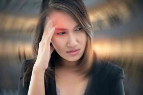 Working woman has Headache Against gray background, Benign Paroxysmal Positional Vertigo: BPPV, Concept with Sickness and Healthcare.